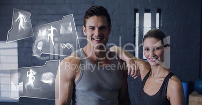 Athletic fit couple in gym with health interface