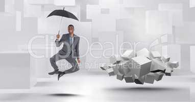 Man with umbrella floating next to geometric surreal cubes