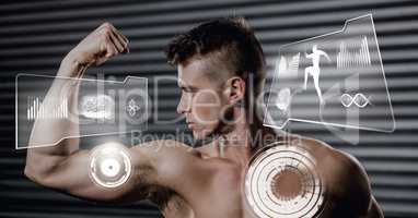 Athletic fit man flexing muscles in gym with health interface