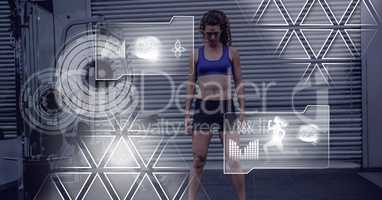 Athletic fit woman in gym with health interface