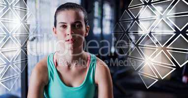 Athletic fit woman in gym with triangles interface