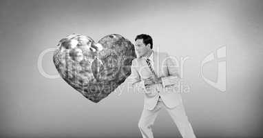 Businessman leaning against surreal heart