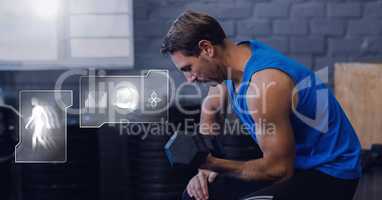 Athletic fit man in gym with health interface