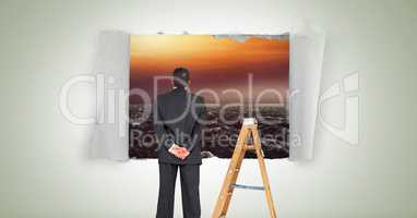 Businessman looking through paper hole with sea and ladder