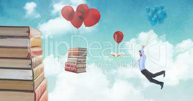 Man holding balloons and floating books on balloons in surreal sky