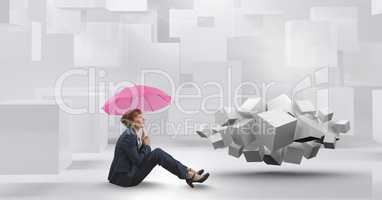 Woman sitting with umbrella next to geometric surreal cubes