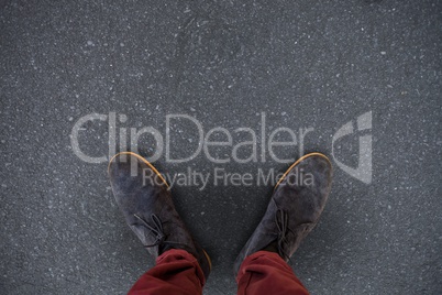 Composite image of high angle view of man wearing shoes