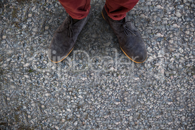 Composite image of high angle view of man wearing shoes