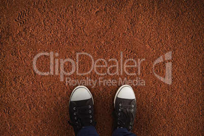 Composite image of businessman wearing canvas shoes standing against white background