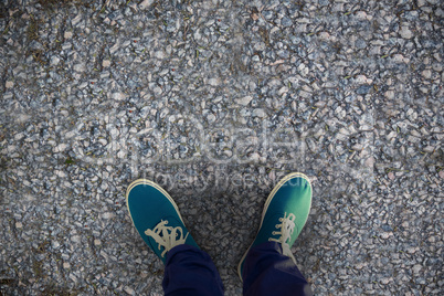 Composite image of man with canvas shoes on hardwood floor