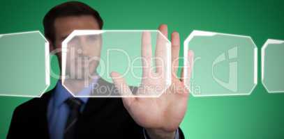 Composite image of close up of businessman touching palm on invisible interface
