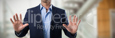 Composite image of businessman touching the invisible screen