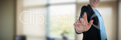 Composite image of mid section of smiling businesswoman touching imaginary interface