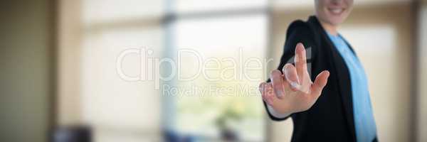 Composite image of mid section of smiling businesswoman touching imaginary interface