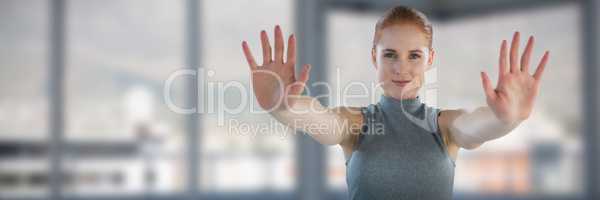 Composite image of portrait of smiling businesswoman showing stop gesture