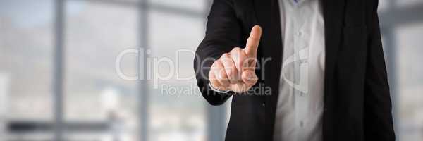 Composite image of businessman standing and pointing