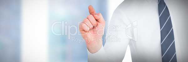 Composite image of businessman pointing with his finger