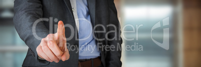 Composite image of businessman in grey suit pointing