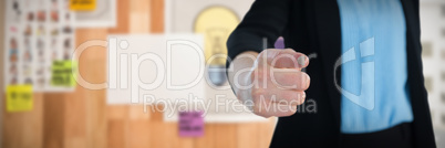 Composite image of mid section of businesswoman touching imaginary interface