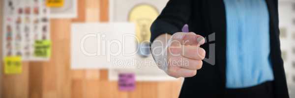 Composite image of mid section of businesswoman touching imaginary interface