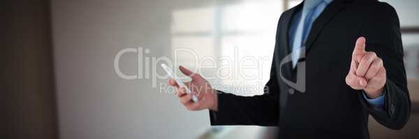 Composite image of mid section of businessman holding mobile phone while using interface screen