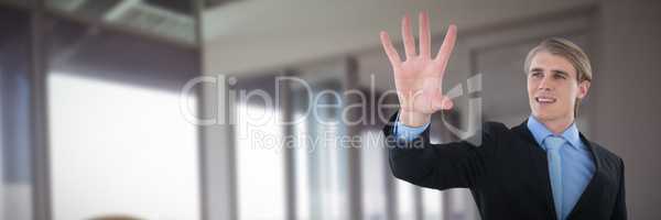 Composite image of smiling businessman gesturing on invisible interface