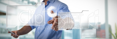 Composite image of male executive pressing an invisible virtual screen while using mobile phone