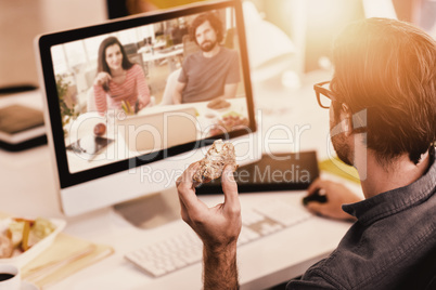 Composite image of graphic designers working at desk