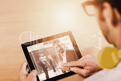 Composite image of cropped image of man with digital tablet