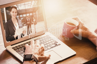 Composite image of cropped image of man using laptop