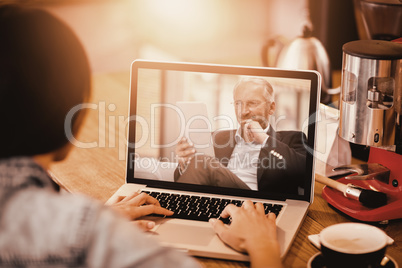 Composite image of woman using laptop at office