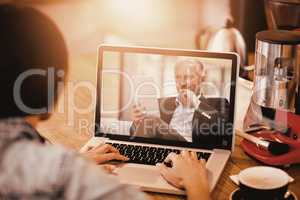 Composite image of woman using laptop at office