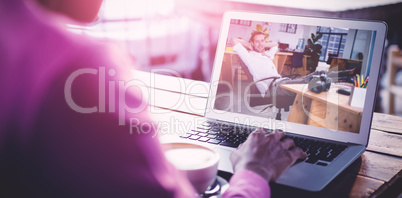 Composite image of woman using laptop in cafe