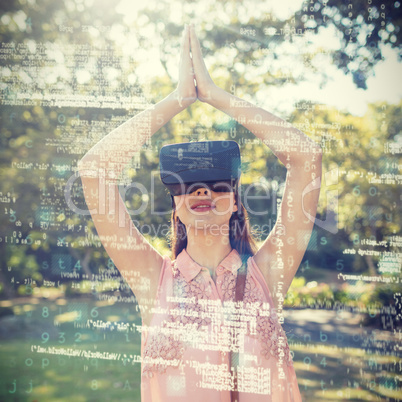 Woman standing with her hands joint while using a VR 3d headset in the park