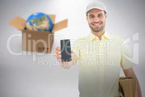 Composite 3d image of handsome delivery man showing mobile phone