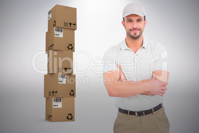Composite image of delivery man standing arms crossed