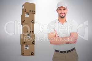 Composite image of delivery man standing arms crossed