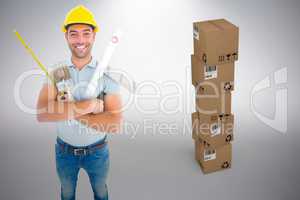 Composite image of portrait of happy manual worker holding various tools