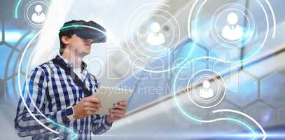 Composite image of young man holding digital tablet while using virtual reality simulator glasses