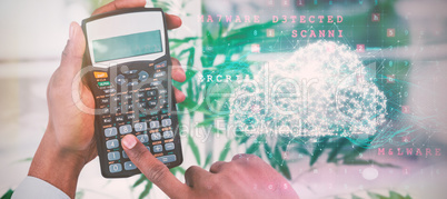 Composite image of cropped hands of businessman using calculator