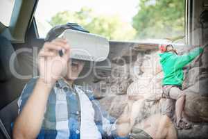Composite image of boy using virtual reality headset