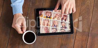 Composite image of man using digital tablet while having cup of coffee