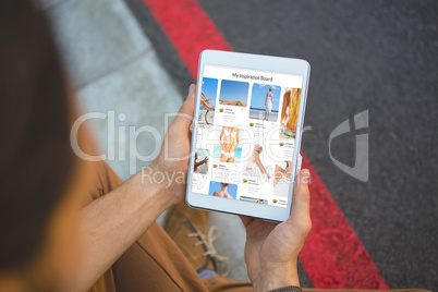 Composite image of cropped hands of man holding tablet
