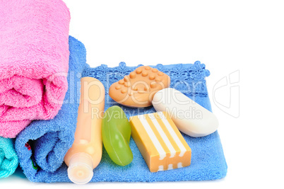 Cotton towels, cosmetic soap and shampoo isolated on white backg