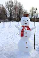 Snowman cheerful. New Year attribute. Christmas snowman made in the garden