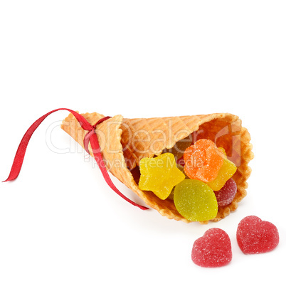 Marmalade candies in a waffle horn isolated on white background.