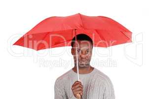 Black man standing and holding a red umbrella