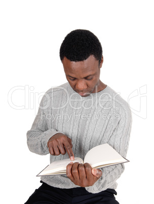 African man sitting and reading his book