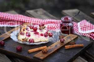 piece of cottage cheese cake and cherry berries on a glass plate