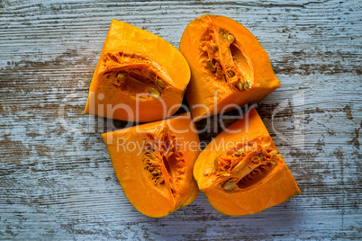 Ripe pumpkin pieces on the gray table